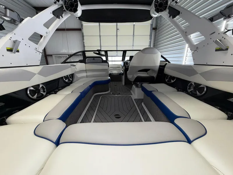 Slide: The Image of 2017 Malibu Wakesetter 23 LSV interior with white and blue seating, modern design. - 9