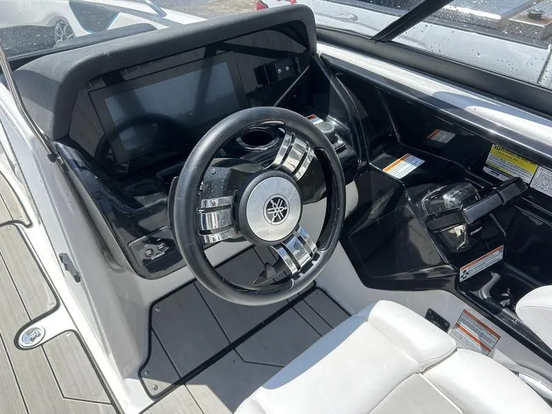 Slide: The Image of 2022 Yamaha Boats 212XE dashboard with steering wheel and controls. - 4