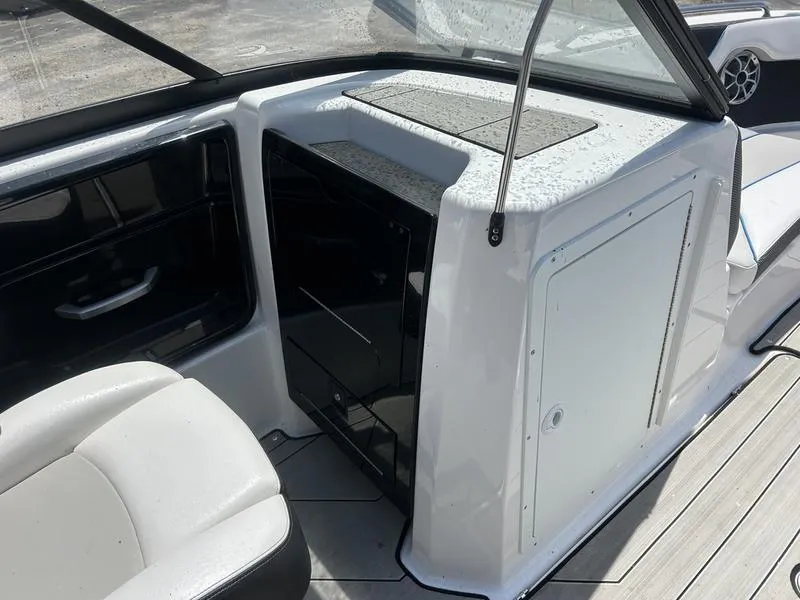 Slide: The Image of 2022 Yamaha Boats 212XE interior with seating and storage compartments. - 5