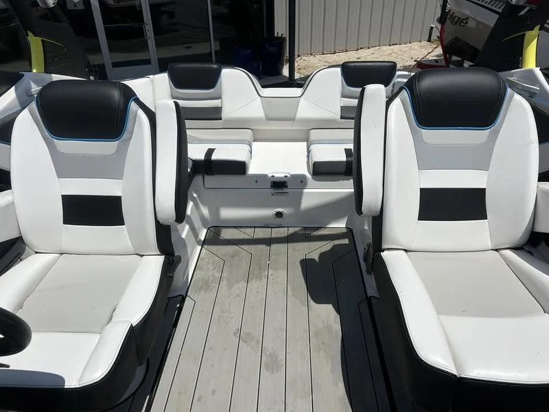 Slide: The Image of 2022 Yamaha Boats 212XE interior with white and black seating, modern design. - 6