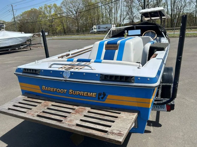 Slide: The Image of 1980 Ski Supreme boat, blue and white, parked outdoors with "Barefoot Supreme" branding. - 11