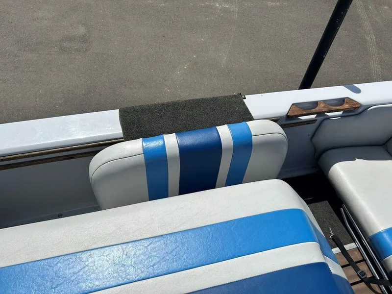 Slide: The Image of 1980 Ski Supreme boat interior with blue and white striped seats. - 12