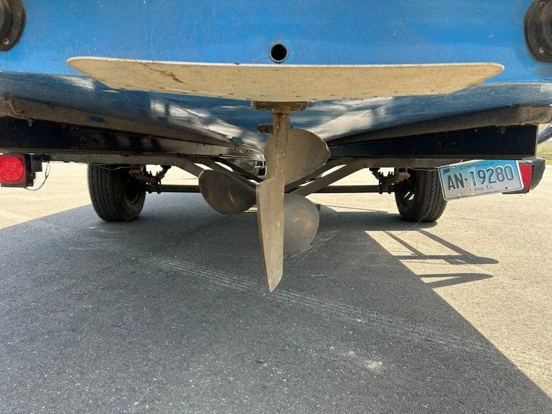 Slide: The Image of 1980 Ski Supreme boat propeller and rudder, rear view, with visible license plate. - 13