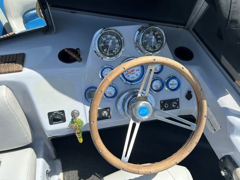 Slide: The Image of 1980 Ski Supreme boat dashboard with wooden steering wheel and vintage gauges. - 15