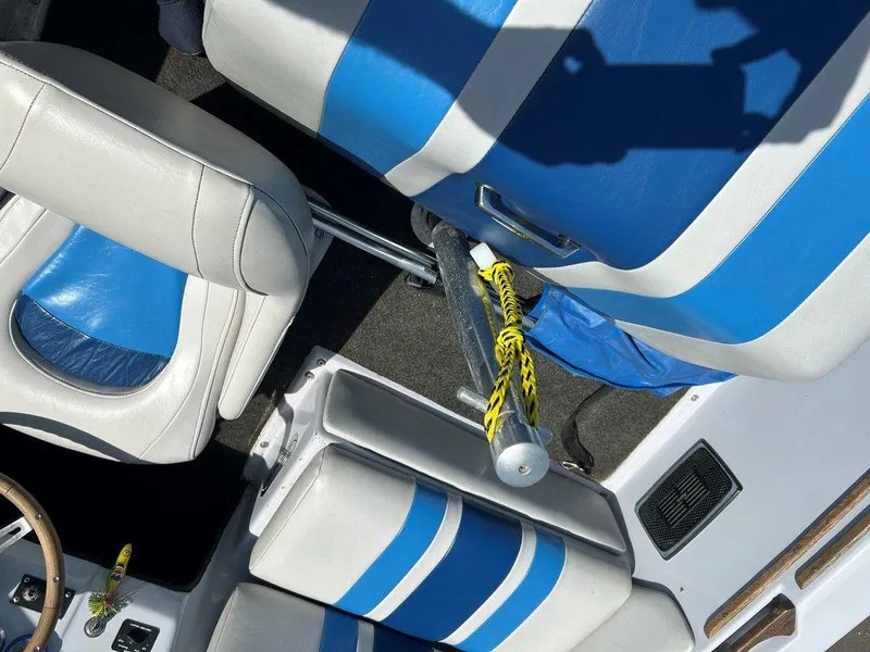 Slide: The Image of 1980 Ski Supreme boat interior with blue and white seats, yellow rope, and wooden accents. - 17