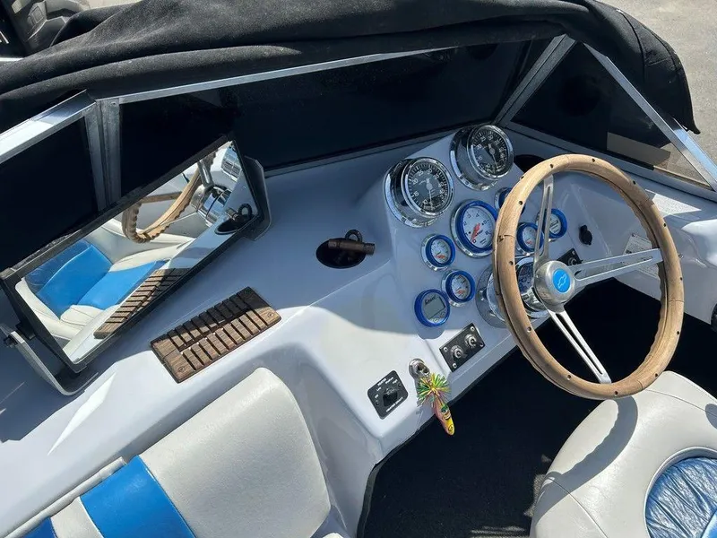 Slide: The Image of 1980 Ski Supreme boat dashboard with gauges, wooden steering wheel, and blue-accented seats. - 18