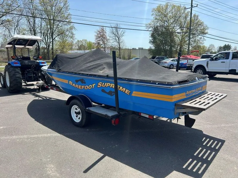 Slide: The Image of 1980 Ski Supreme boat with cover, on trailer, parked outdoors. - 7