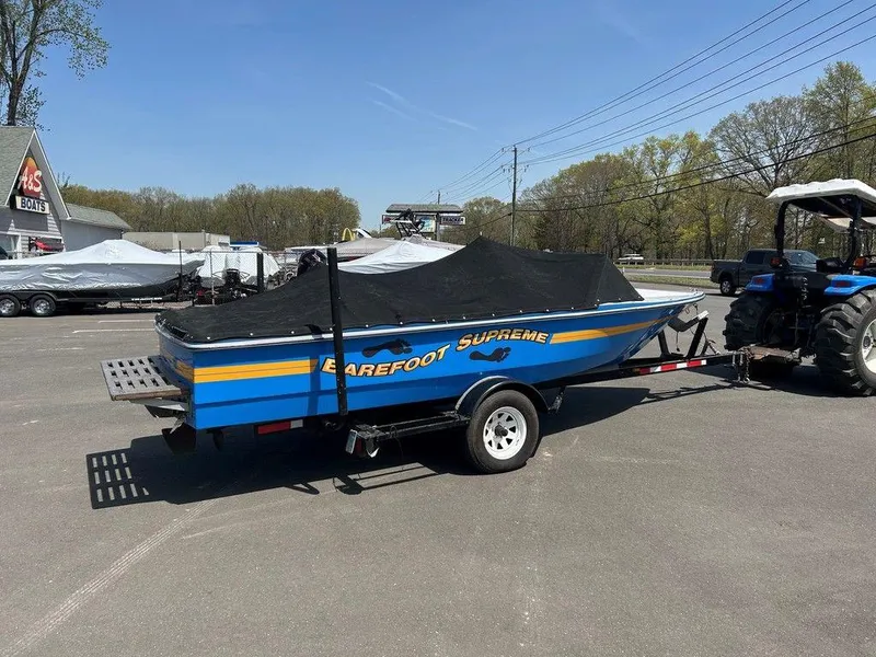 Slide: The Image of 1980 Ski Supreme boat on trailer, covered, parked outdoors. - 8