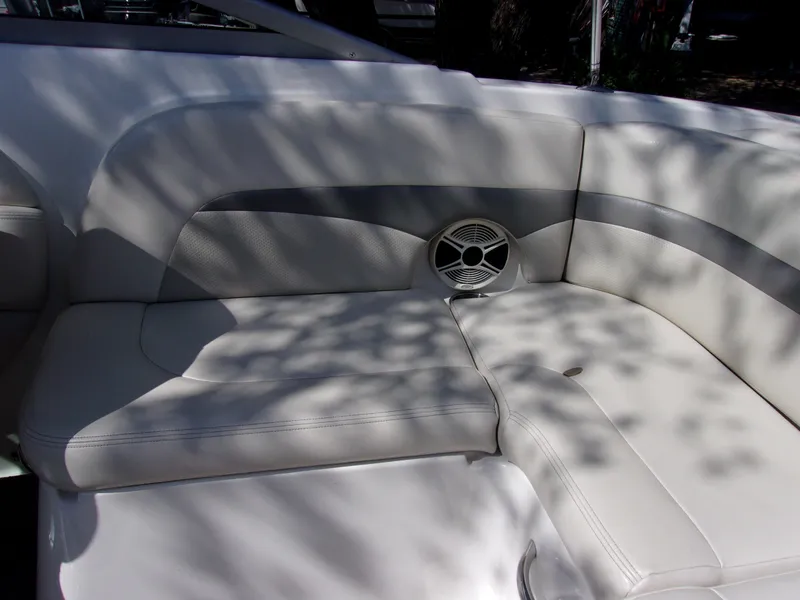 Slide: The Image of 2009 Chaparral 226 SSi boat interior with white cushioned seating and speaker. - 12