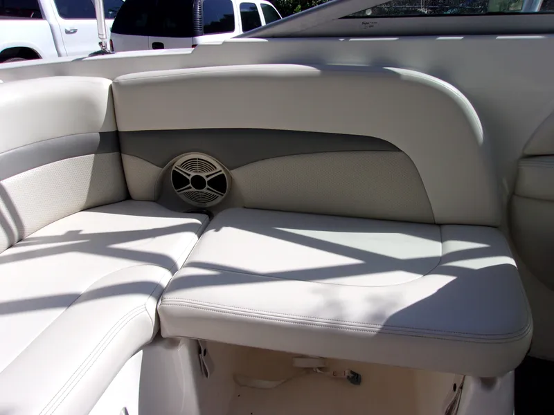 Slide: The Image of 2009 Chaparral 226 SSi boat interior with white cushioned seating and speaker. - 13