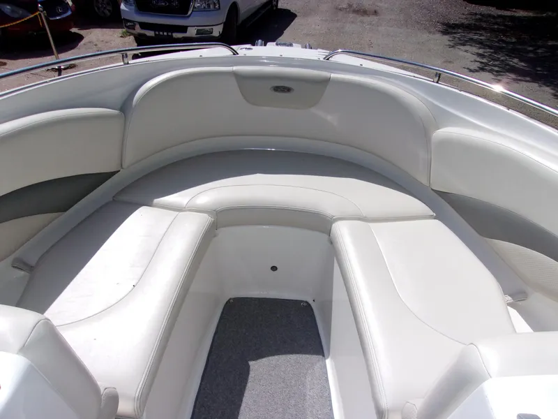 Slide: The Image of 2009 Chaparral 226 SSi boat interior with white seating and carpeted floor. - 15