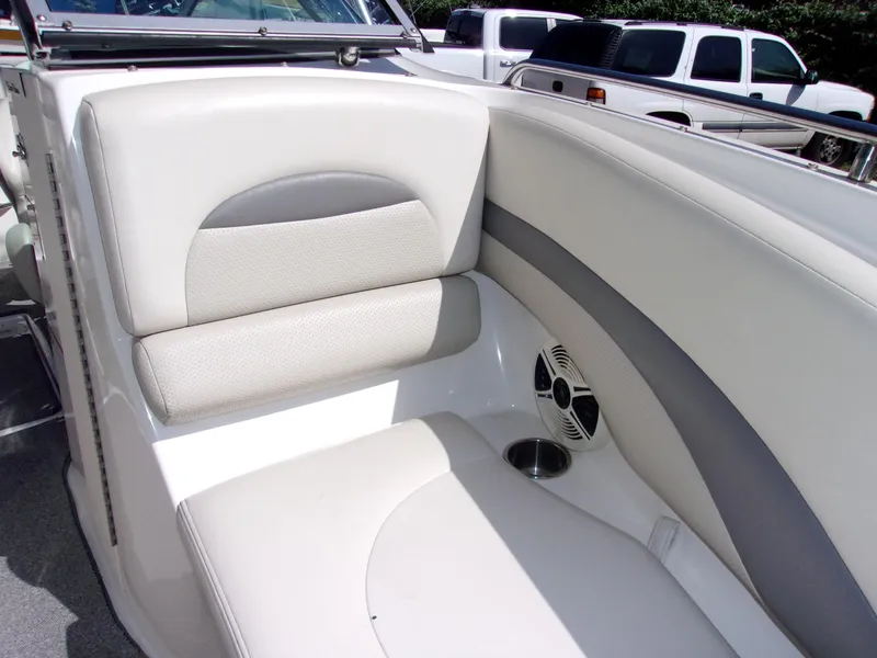 Slide: The Image of 2009 Chaparral 226 SSi boat interior with white and gray seating and speaker. - 16