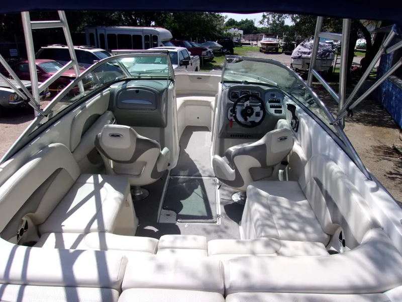 Slide: The Image of 2009 Chaparral 226 SSi boat interior with seating and steering wheel, parked outdoors. - 4