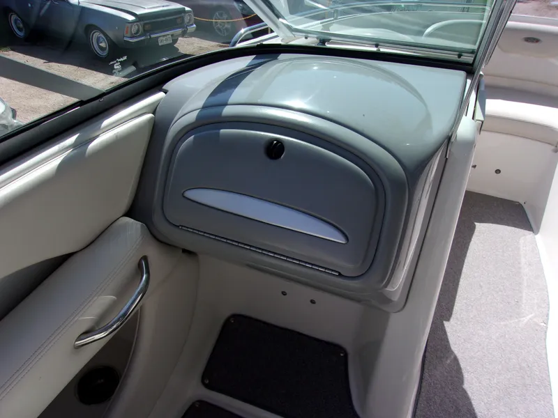 Slide: The Image of 2009 Chaparral 226 SSi boat interior with glove compartment and seating area. - 6