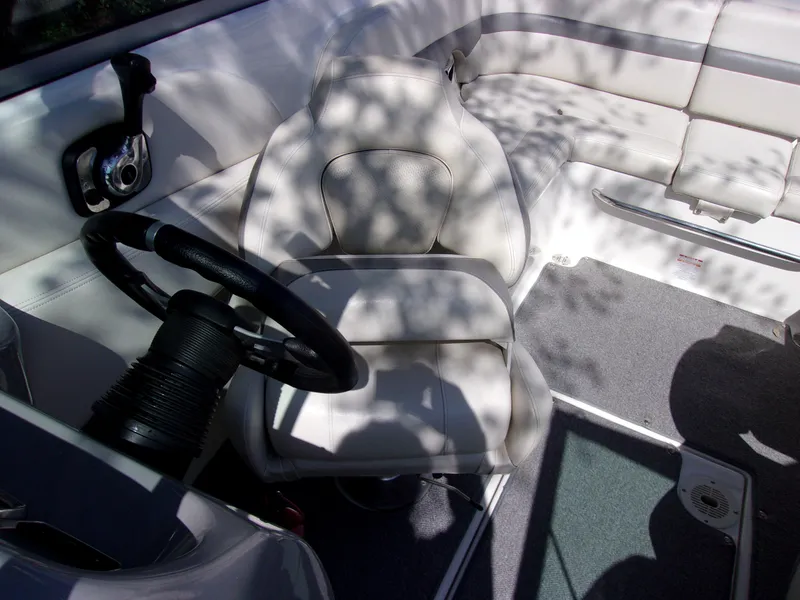 Slide: The Image of 2009 Chaparral 226 SSi boat interior with steering wheel and seating. - 8