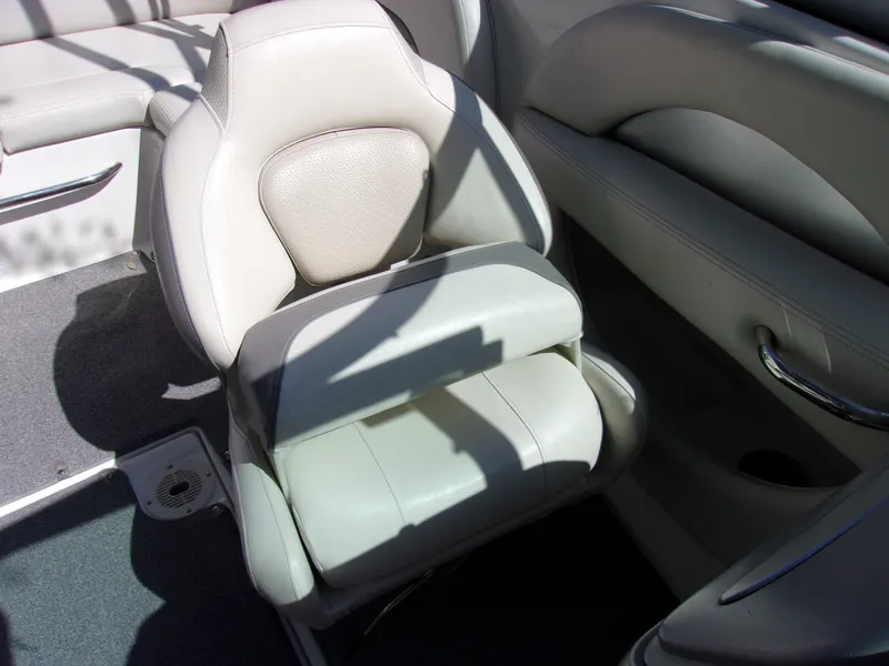 Slide: The Image of 2009 Chaparral 226 SSi boat interior with beige seating and armrest. - 9