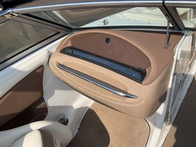 Slide: The Image of Interior of a 2013 Cobalt 210 boat, featuring beige and brown upholstery. - 12