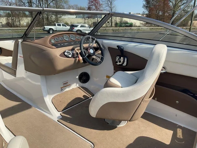 Slide: The Image of Interior of a 2013 Cobalt 210 boat with beige and white seating. - 13