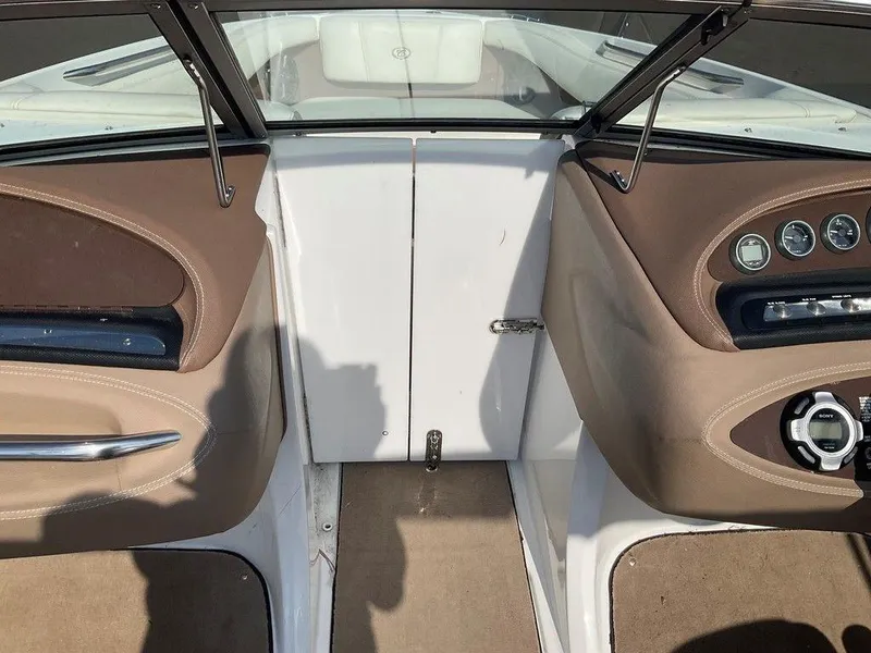 Slide: The Image of Interior view of a 2013 Cobalt 210 boat cockpit with brown and beige accents. - 15