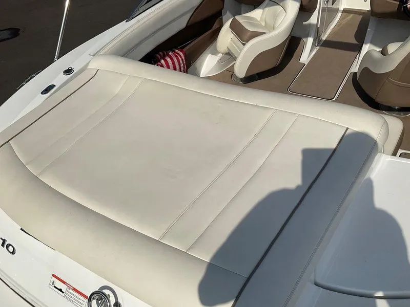 Slide: The Image of 2013 Cobalt 210 boat interior with white leather seating and brown accents. - 2