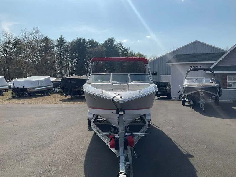 Slide: The Image of 2013 Cobalt 210 boat on trailer in outdoor storage area. - 24