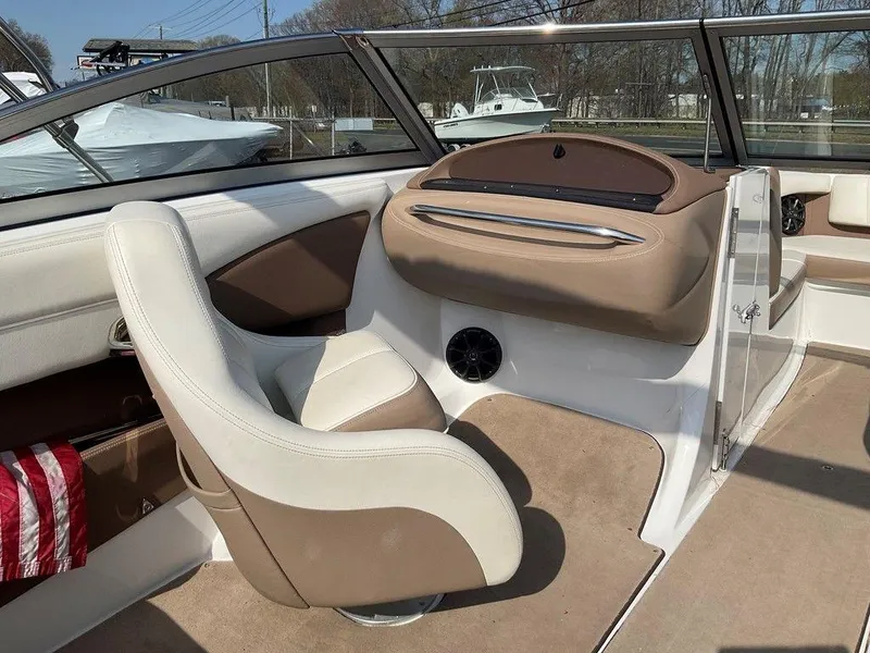 Slide: The Image of Interior of a 2013 Cobalt 210 boat with beige and white seating. - 8