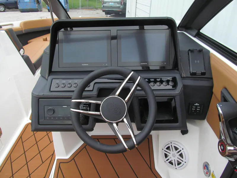 Slide: The Image of 2025 Cobalt R6 boat dashboard with dual screens and modern steering wheel. - 12