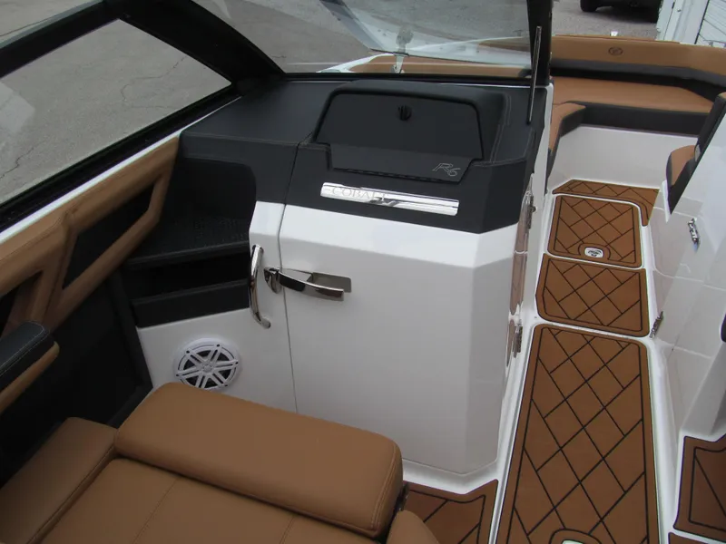 Slide: The Image of 2025 Cobalt R6 boat interior with tan seating and diamond-patterned flooring. - 13