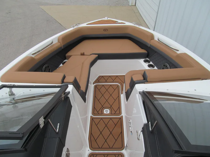 Slide: The Image of 2025 Cobalt R6 boat interior with tan and black seating, diamond-patterned flooring. - 15