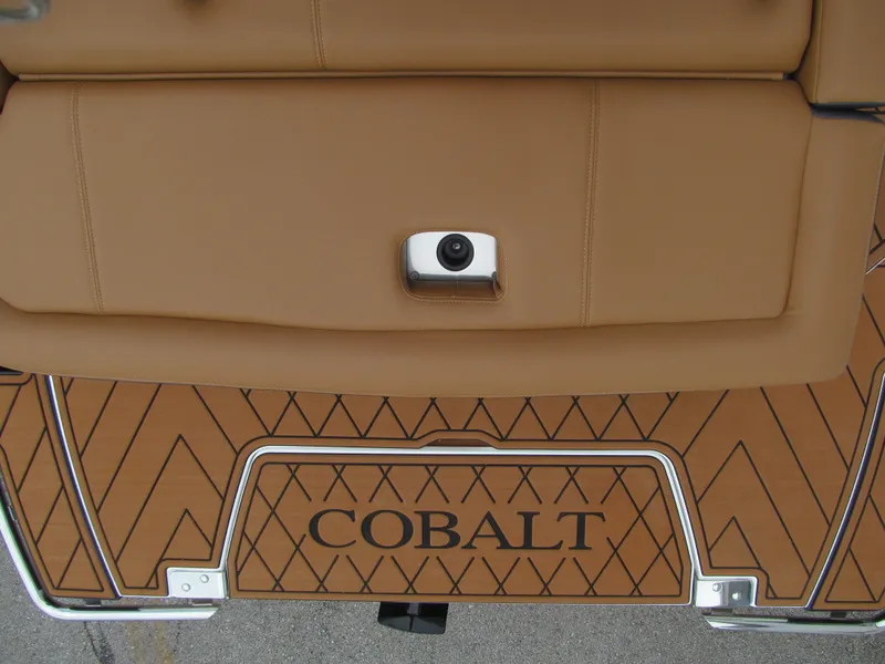 Slide: The Image of 2025 Cobalt R6 boat interior with tan upholstery and diamond-patterned flooring. - 23