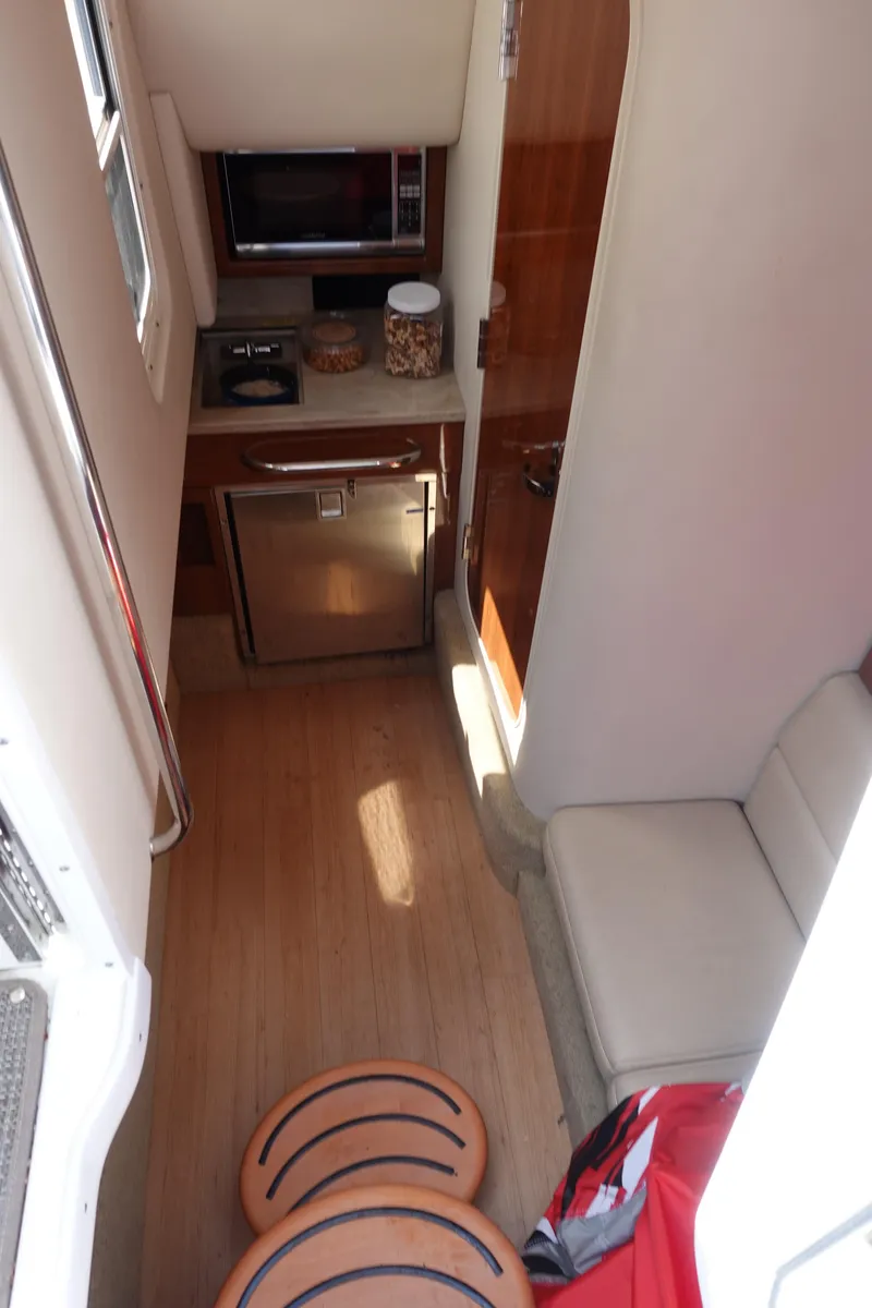 Slide: The Image of 2015 Formula 350 Crossover Bowrider interior with kitchenette and seating area. - 20