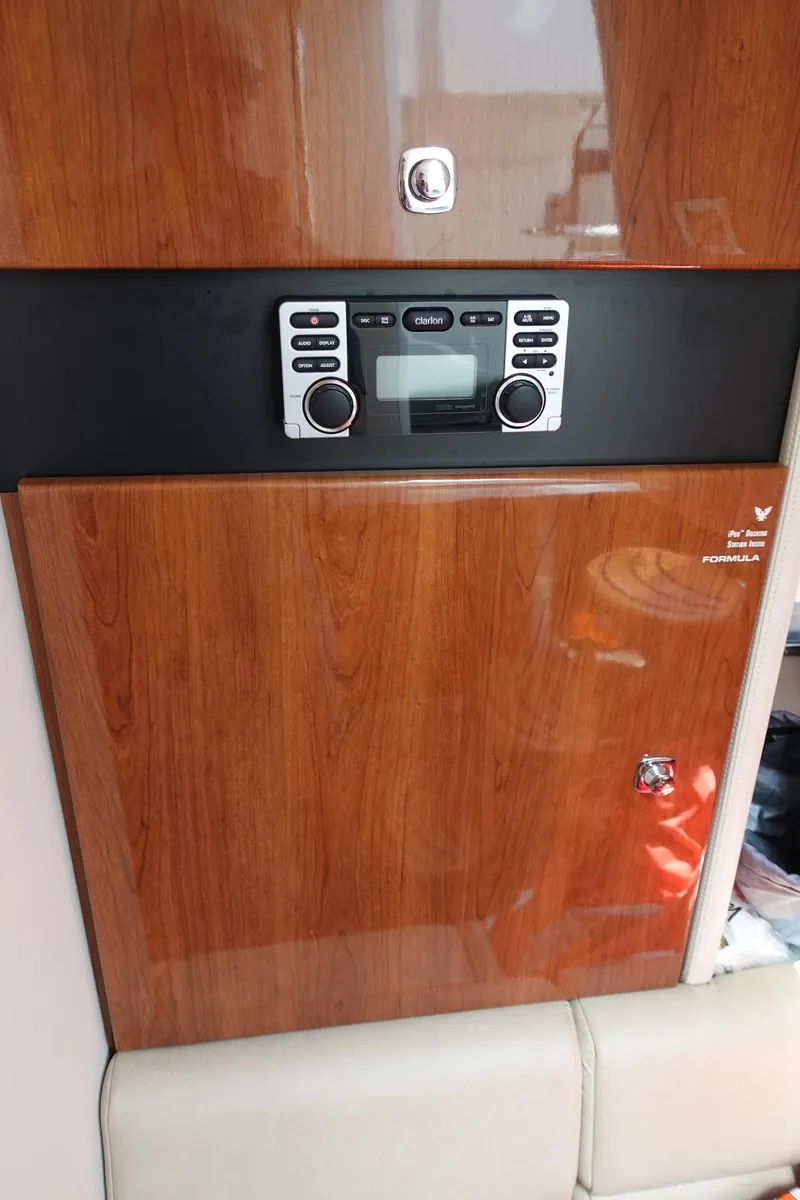 Slide: The Image of 2015 Formula 350 Crossover Bowrider interior with wood paneling and stereo system. - 21