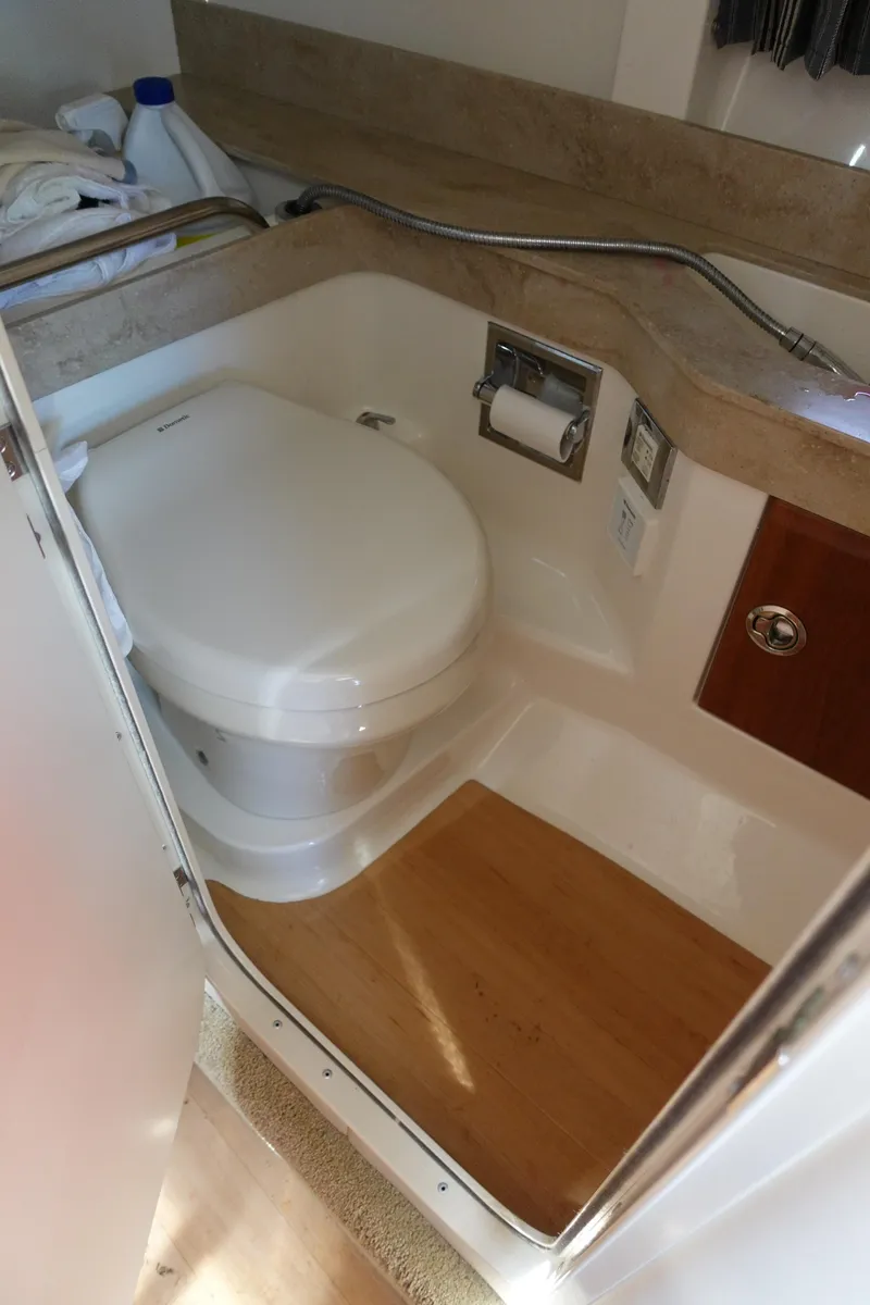 Slide: The Image of 2015 Formula 350 Crossover Bowrider bathroom with compact toilet and wooden flooring. - 23