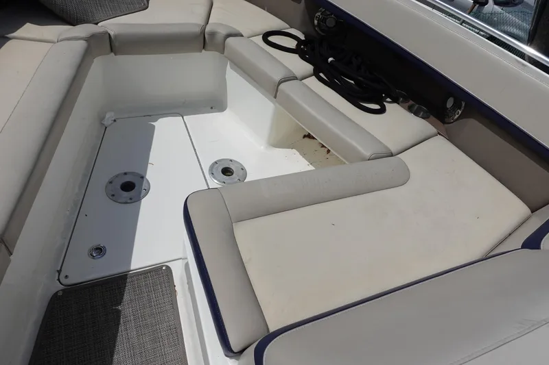 Slide: The Image of 2015 Formula 350 Crossover Bowrider interior seating area with beige cushions and storage space. - 6