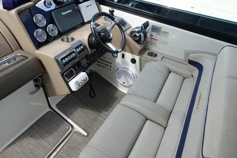 Slide: The Image of 2015 Formula 350 Crossover Bowrider cockpit with steering wheel, controls, and seating. - 8