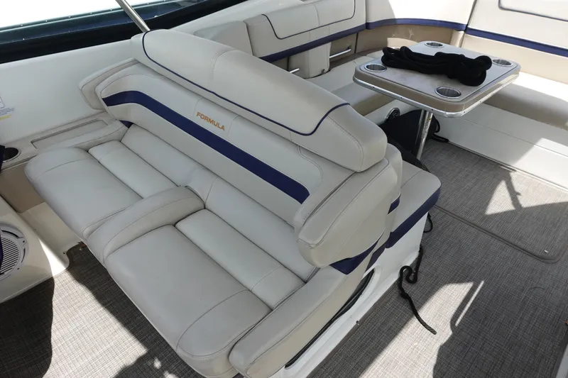 Slide: The Image of 2015 Formula 350 Crossover Bowrider interior with plush seating and table. - 9