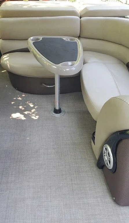 Slide: The Image of 2017 Regency 220 DL3 boat interior with beige seating and a central table. - 14