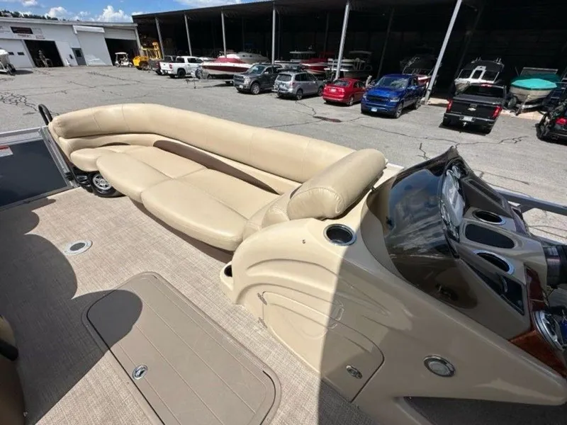 Slide: The Image of 2017 Regency 220 DL3 boat interior with beige seating and control panel. - 2