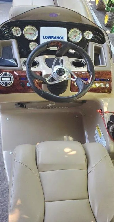 Slide: The Image of Steering console of 2017 Regency 220 DL3 boat with gauges and Lowrance display. - 21