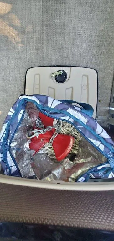 Slide: The Image of Storage compartment on a 2017 Regency 220 DL3 boat with rope and red anchor. - 24