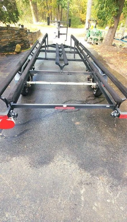 Slide: The Image of Trailer for 2017 Regency 220 DL3 boat, parked on a driveway. - 28