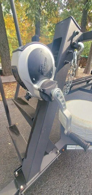 Slide: The Image of 2017 Regency 220 DL3 boat winch mechanism, surrounded by autumn trees. - 32