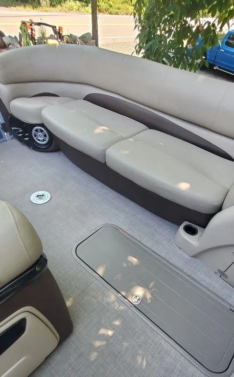 Slide: The Image of 2017 Regency 220 DL3 boat interior with beige seating and storage compartment. - 37