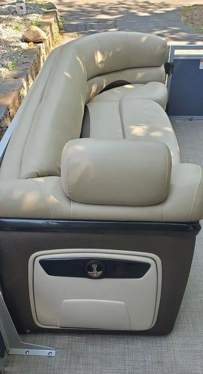 Slide: The Image of 2017 Regency 220 DL3 boat seating with beige upholstery and storage compartment. - 39