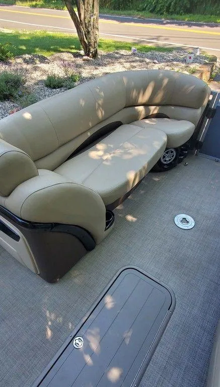 Slide: The Image of 2017 Regency 220 DL3 pontoon boat with beige seating and carpeted deck. - 40