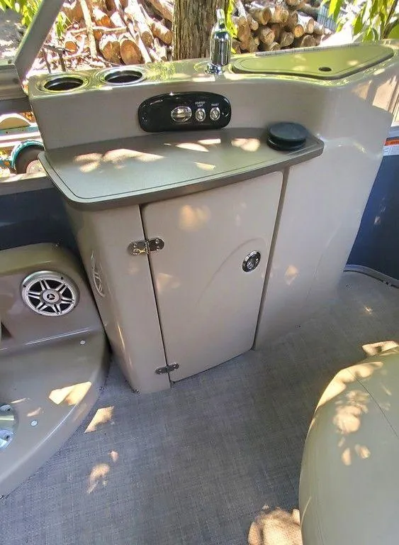 Slide: The Image of 2017 Regency 220 DL3 boat interior with control panel and storage cabinet. - 45