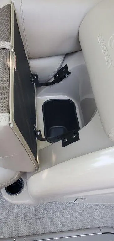Slide: The Image of 2017 Regency 220 DL3 boat seat storage compartment with cup holder. - 46