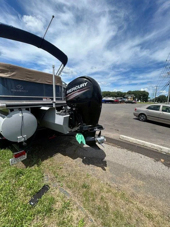 Slide: The Image of 2017 Regency 220 DL3 boat with Mercury outboard motor in parking lot. - 49