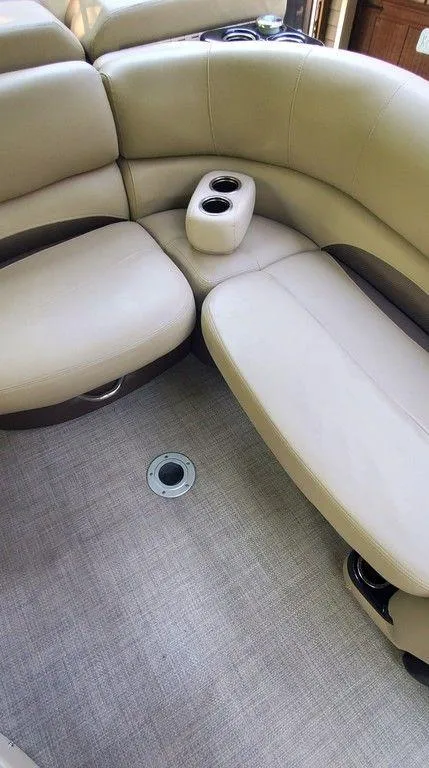 Slide: The Image of Luxurious seating in 2017 Regency 220 DL3 boat with beige upholstery and cup holders. - 5