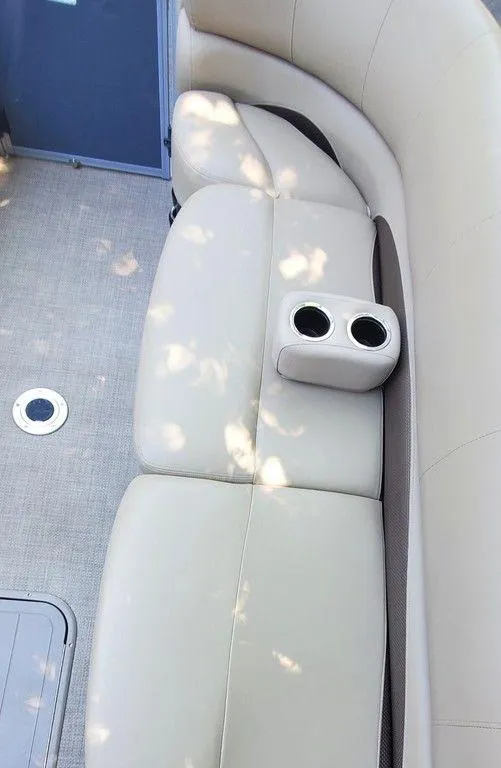 Slide: The Image of Luxurious seating on 2017 Regency 220 DL3 boat with cup holders and beige upholstery. - 7